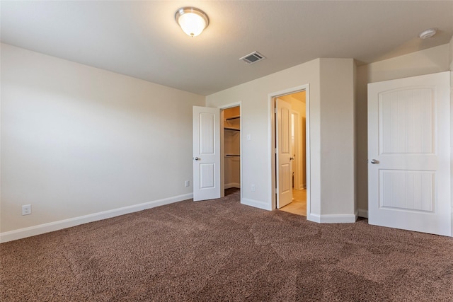 2623 Holbrook Springs Ln, League City, TX 77573 - unfurnished bedroom featuring carpet flooring, visible vents, a closet, baseboards, and a spacious closet
