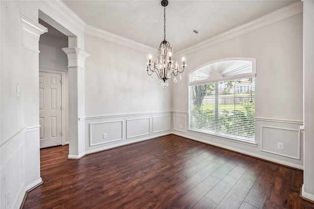 unfurnished room with a decorative wall, a chandelier, dark wood-style floors, wainscoting, and crown molding