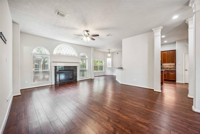 unfurnished living room featuring ceiling fan, dark wood-style floors, baseboards, a premium fireplace, and recessed lighting
