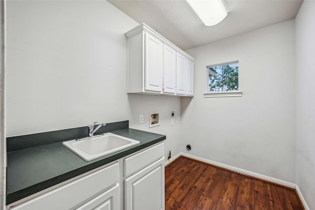 laundry area featuring electric dryer hookup, washer hookup, cabinet space, dark wood finished floors, and gas dryer hookup