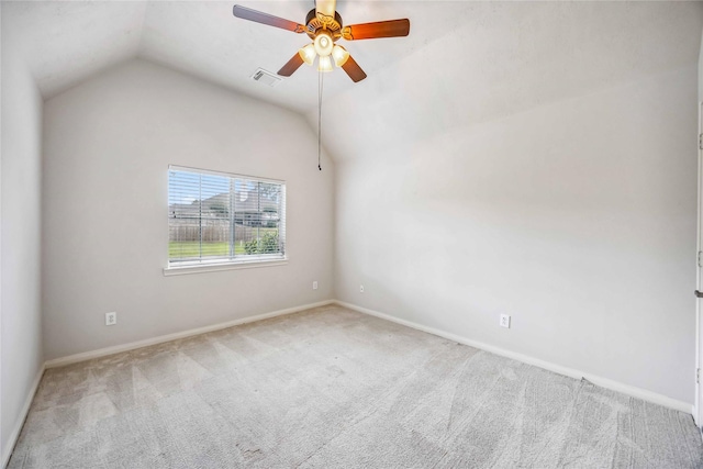 carpeted spare room featuring lofted ceiling, baseboards, and ceiling fan