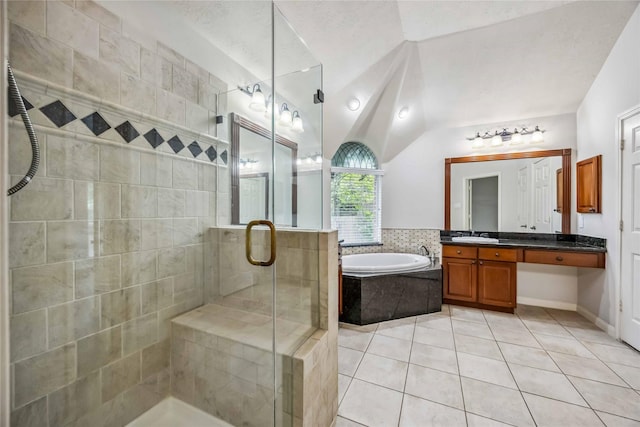 bathroom with a stall shower, a garden tub, tile patterned floors, lofted ceiling, and vanity