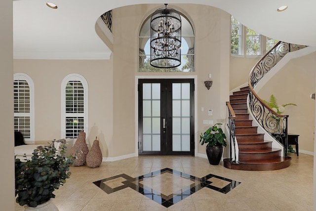 8 Autumn Cres, The Woodlands, TX 77381 - entrance foyer featuring an inviting chandelier, french doors, stairs, and baseboards