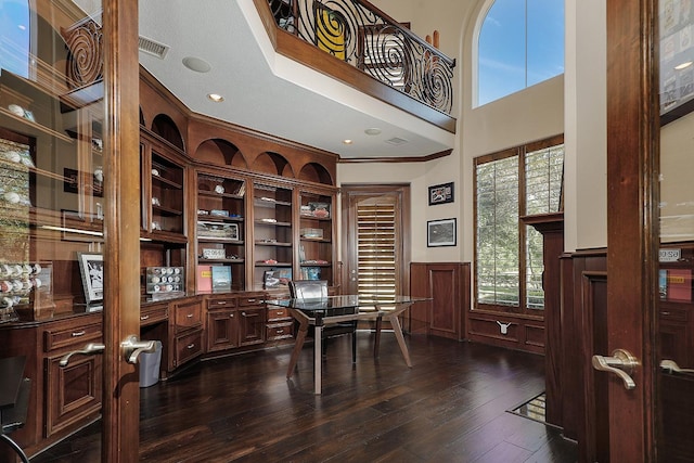 8 Autumn Cres, The Woodlands, TX 77381 - office space with built in desk, dark wood-style flooring, crown molding, a wainscoted wall, and visible vents