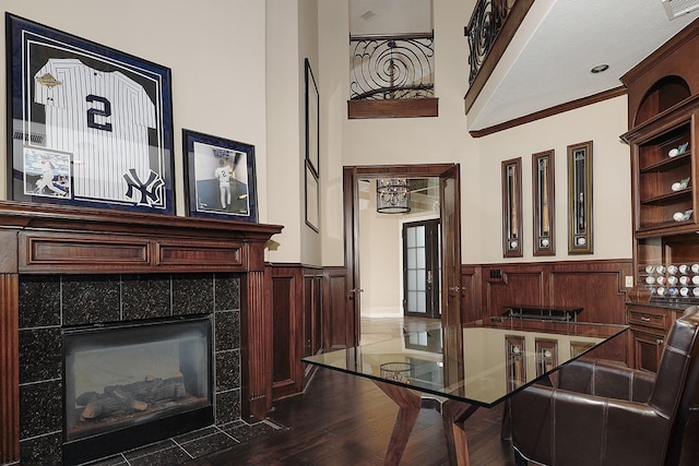 8 Autumn Cres, The Woodlands, TX 77381 - interior space featuring dark wood-style floors, a wainscoted wall, crown molding, and a fireplace