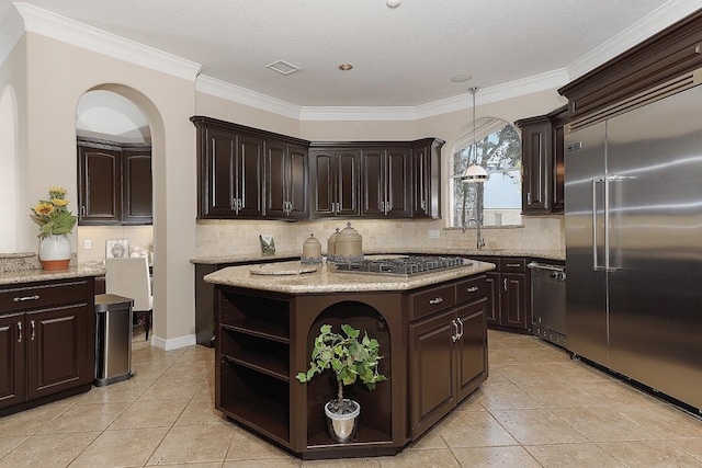 8 Autumn Cres, The Woodlands, TX 77381 - kitchen with tasteful backsplash, open shelves, appliances with stainless steel finishes, visible vents, and dark brown cabinetry