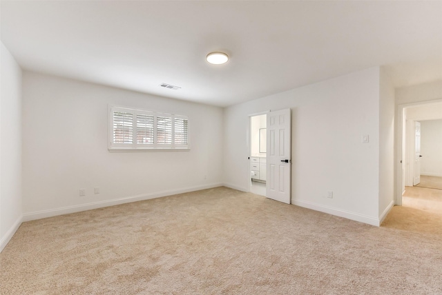 empty room with baseboards, visible vents, and carpet flooring