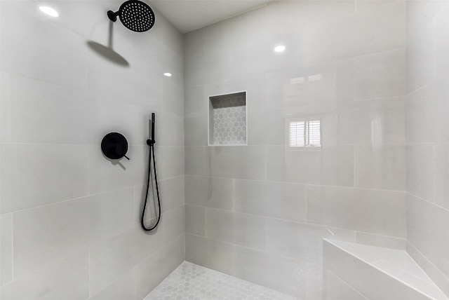 bathroom with a tile shower