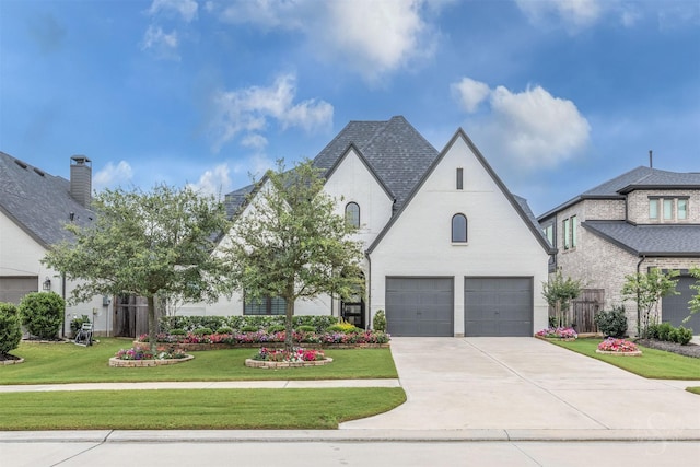 4123 Ana Ridge Ln, Fulshear, TX 77441 - french country style house with a front yard, a garage, and driveway