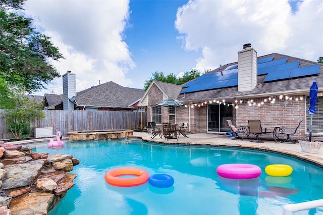 view of swimming pool with outdoor dining area, a patio area, a fenced in pool, a fenced backyard, and an in ground hot tub
