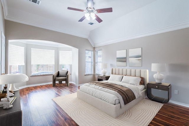 bedroom featuring baseboards, arched walkways, wood finished floors, and lofted ceiling