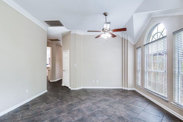 spare room with stone finish floor, visible vents, a ceiling fan, and baseboards