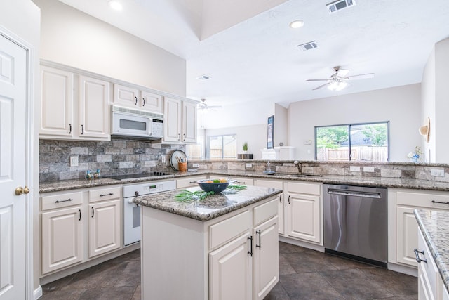 kitchen with white cabinetry, white appliances, a ceiling fan, and a sink