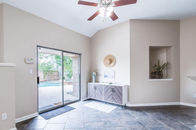 unfurnished room with lofted ceiling, ceiling fan, and baseboards