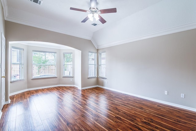 unfurnished room with visible vents, a ceiling fan, a healthy amount of sunlight, and dark wood-style flooring