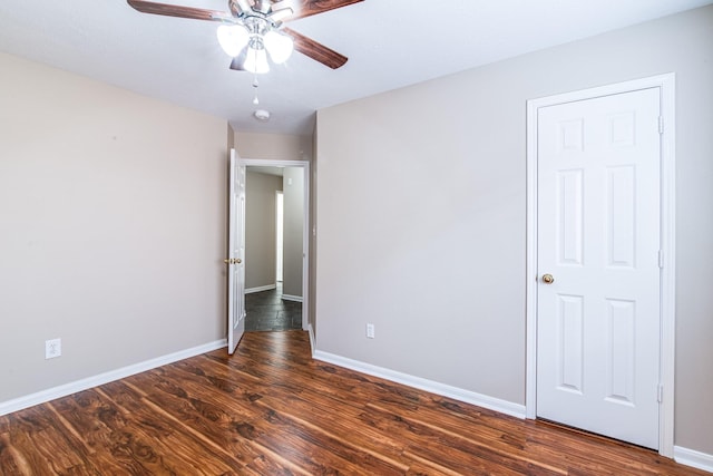 unfurnished bedroom featuring ceiling fan, wood finished floors, and baseboards
