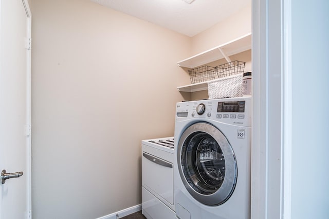 laundry area featuring baseboards, laundry area, and washing machine and dryer