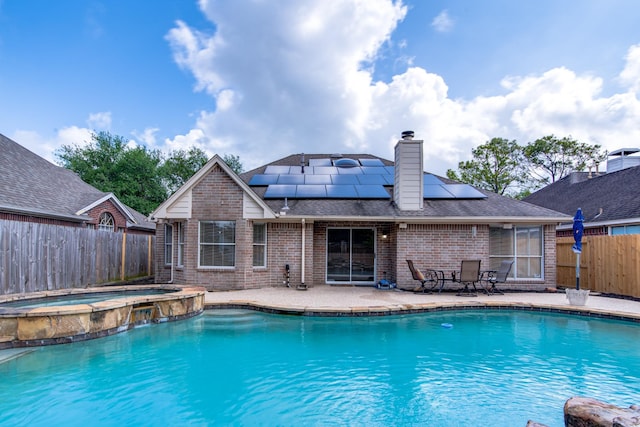 view of swimming pool with a patio, a fenced backyard, and a pool with connected hot tub