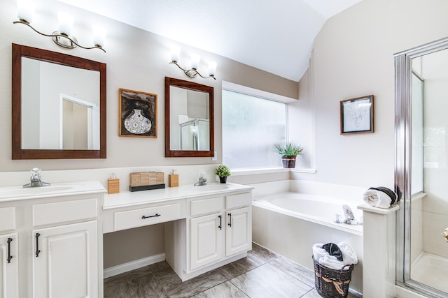 full bathroom featuring double vanity, a sink, a shower stall, and vaulted ceiling