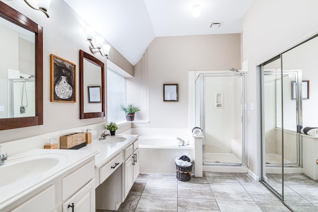 bathroom with a sink, visible vents, a stall shower, two vanities, and a garden tub