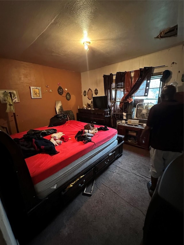 bedroom featuring a textured ceiling and carpet floors
