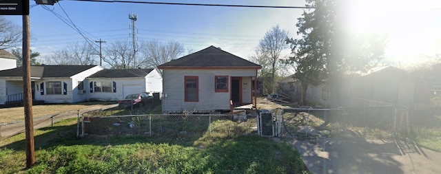 view of front of house featuring a gate, cooling unit, and fence private yard