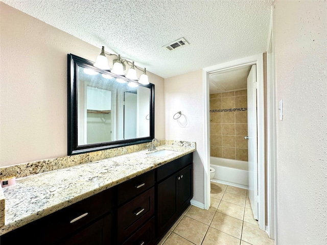 12550 Whittington Dr Unit 1015, Houston, TX 77077 - full bath featuring a textured ceiling, visible vents, toilet, vanity, and tile patterned flooring