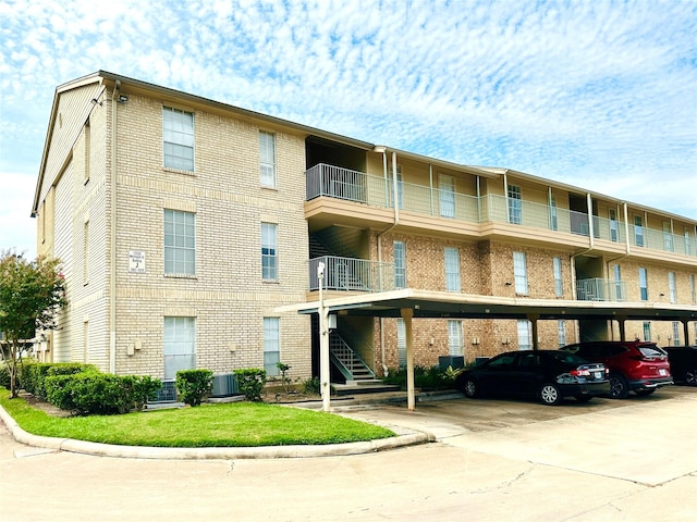 12550 Whittington Dr Unit 1015, Houston, TX 77077 - view of building exterior featuring central AC and covered parking