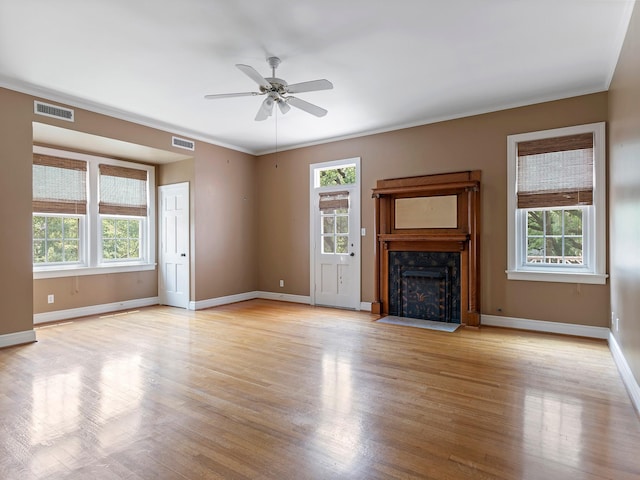 unfurnished living room featuring visible vents, a ceiling fan, light wood-style flooring, and a high end fireplace