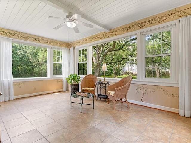 sunroom with tile patterned floors and baseboards