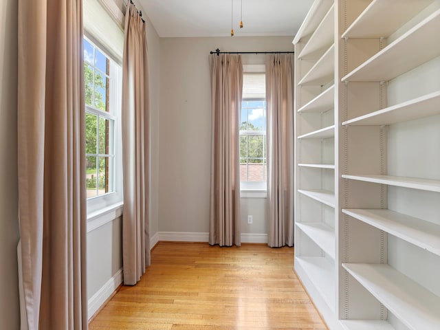 spare room featuring light wood-style flooring and baseboards