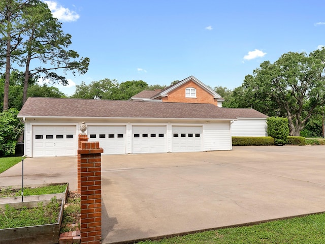 view of front of property with a garage and concrete driveway