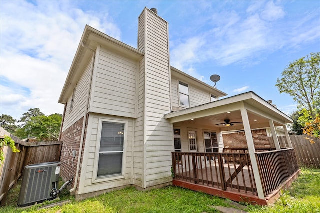 back of house featuring ceiling fan, a chimney, central AC, brick siding, and fence