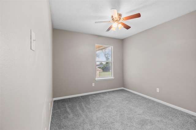 carpeted empty room with baseboards and ceiling fan