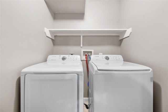 clothes washing area with washer and dryer and laundry area
