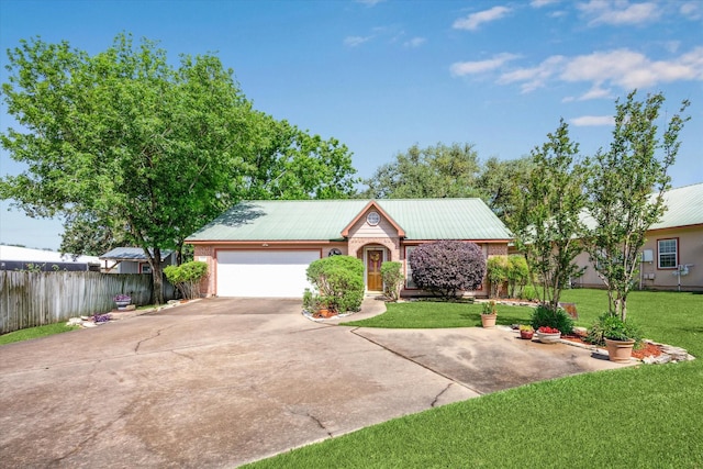 single story home featuring driveway, metal roof, a front yard, fence, and a garage