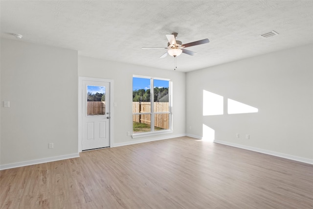 520 Shoreview Dr, Conroe, TX 77303 - empty room featuring a textured ceiling, visible vents, light wood-style floors, baseboards, and a ceiling fan