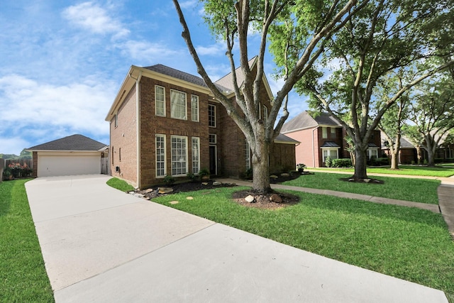 traditional-style house with concrete driveway, brick siding, a garage, and a front lawn
