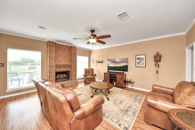 living room featuring baseboards, plenty of natural light, and light wood-type flooring