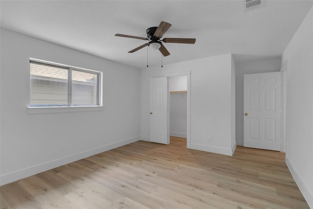 unfurnished bedroom featuring visible vents, light wood-style floors, and baseboards