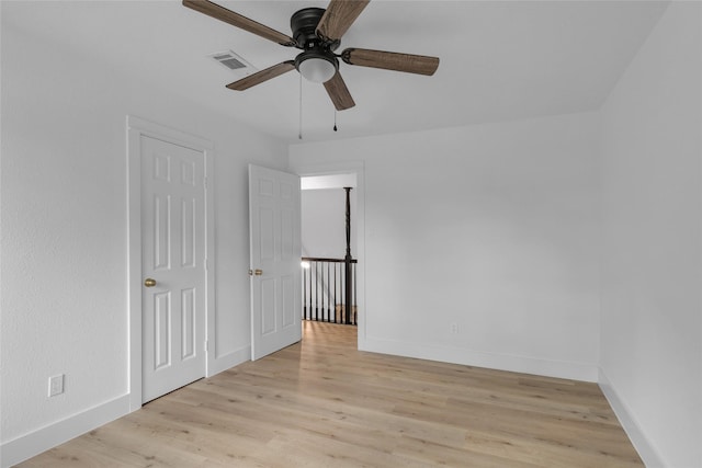 unfurnished bedroom featuring visible vents, light wood-style flooring, and baseboards