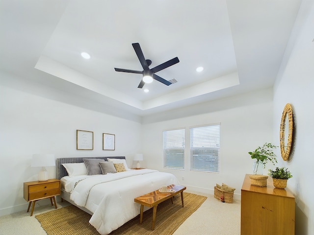 bedroom with ceiling fan, a tray ceiling, baseboards, carpet floors, and recessed lighting