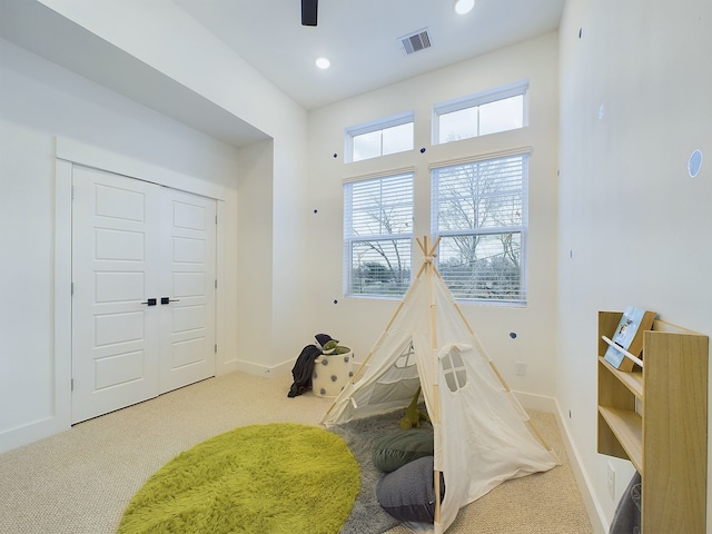 rec room with visible vents, baseboards, a ceiling fan, and carpet floors