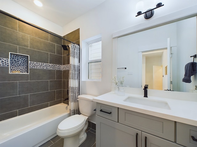 bathroom featuring toilet, shower / tub combo, vanity, and tile patterned floors