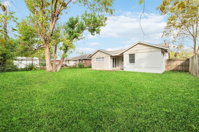 4517 W 43rd St, Houston, TX 77092 - back of house featuring brick siding, a fenced backyard, and a lawn