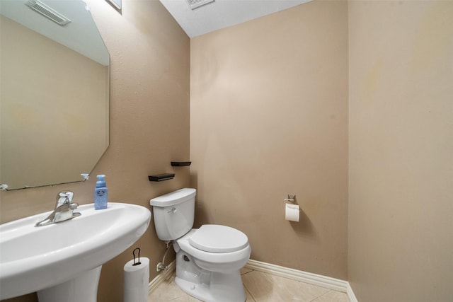 15015 Cozy Hollow Ln, Houston, TX 77044 - half bathroom with toilet, baseboards, and tile patterned flooring