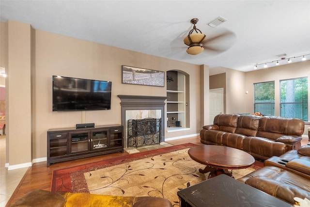 15015 Cozy Hollow Ln, Houston, TX 77044 - living area with built in features, ceiling fan, a fireplace, wood finished floors, and baseboards
