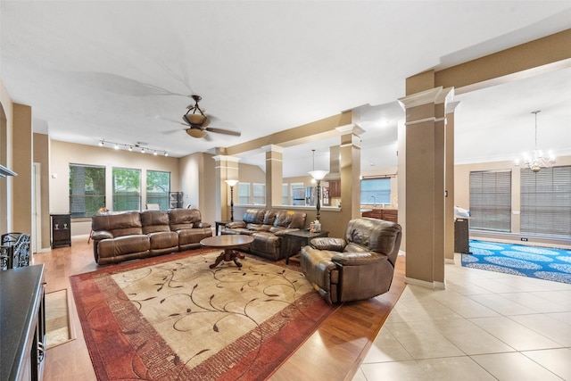 15015 Cozy Hollow Ln, Houston, TX 77044 - living area with ceiling fan, decorative columns, light tile patterned floors, and a chandelier