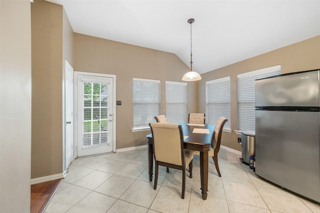 15015 Cozy Hollow Ln, Houston, TX 77044 - dining area with lofted ceiling, baseboards, and light tile patterned flooring