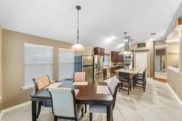 15015 Cozy Hollow Ln, Houston, TX 77044 - dining space with lofted ceiling, light tile patterned floors, and baseboards